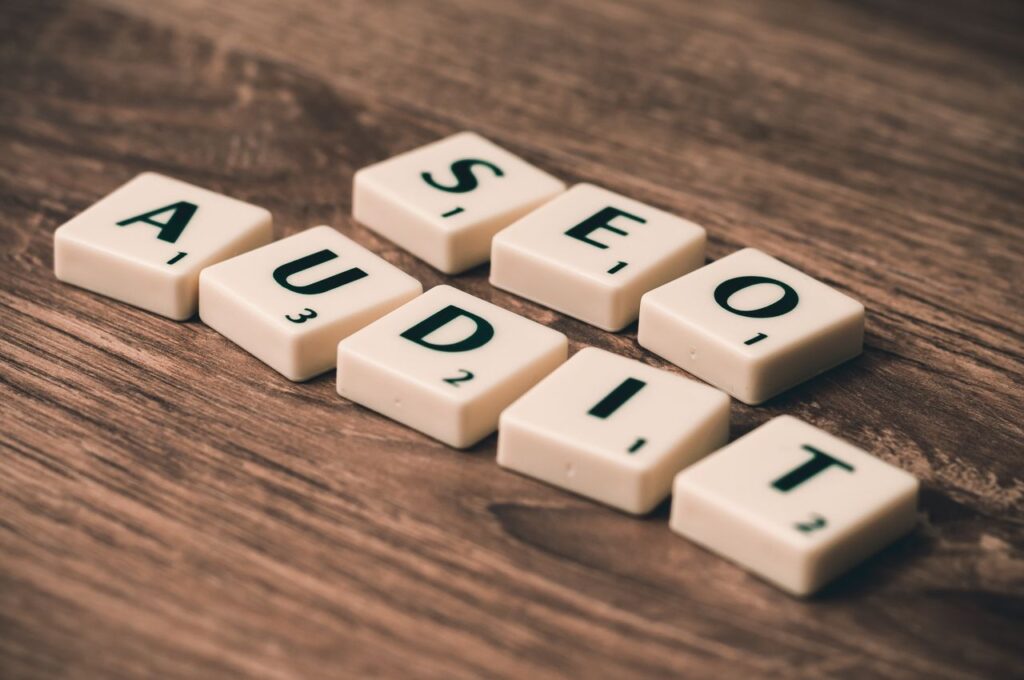 pexels photo 267415 267415 Scrabble tiles spelling SEO Audit on wooden surface, symbolizing digital marketing strategies.