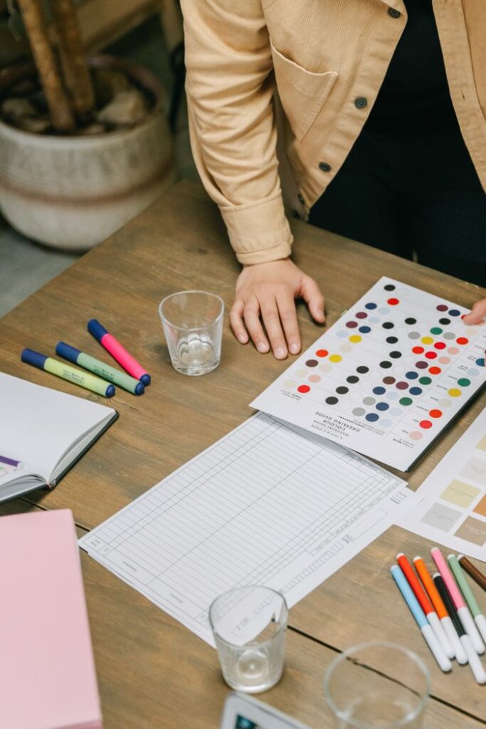 pexels photo 8117439 8117439 A designer's workspace with a focus on color planning and organization.